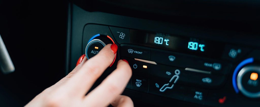 Women adjusting ac temperature in car