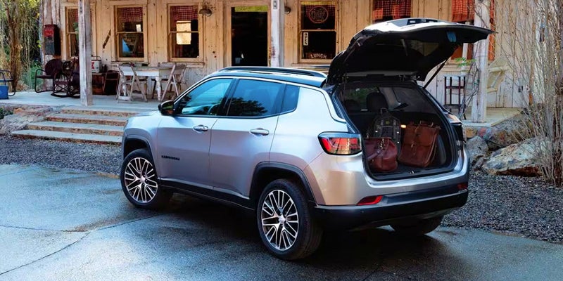 Silver Jeep Compass with luggage in trunk